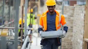 male construction worker carrying brick 260nw 2202322667